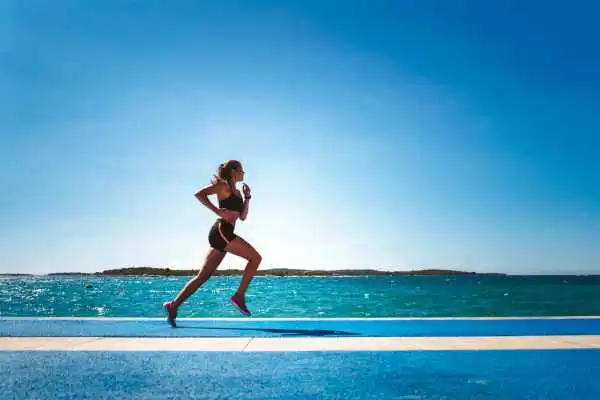 Woman running showing strong leg muscle Macclesfield